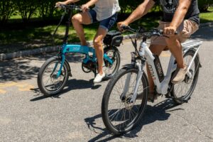 A couple enjoying a ride on electric bikes during a sunny day in Patchogue, NY.